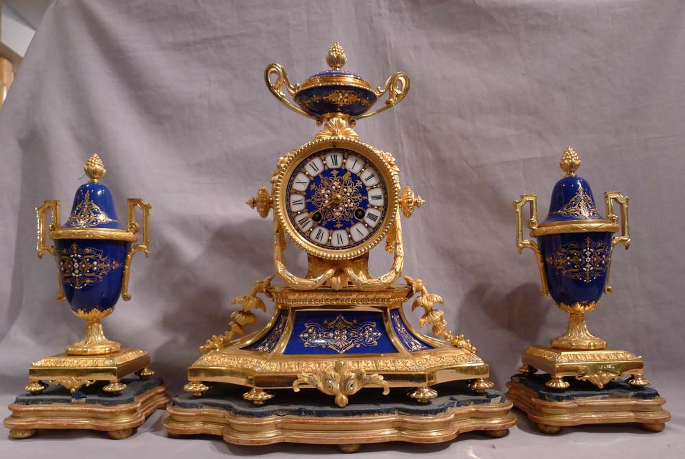 Antique French clock garniture in ormolu and enamelled ( jewelled) porcelain.