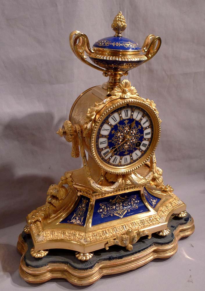 Antique French clock garniture in ormolu and enamelled ( jewelled) porcelain.