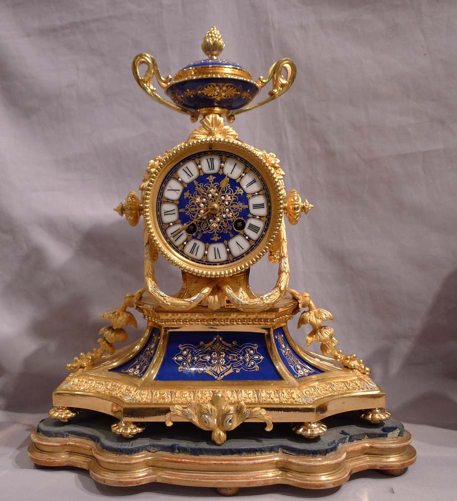 Antique French clock garniture in ormolu and enamelled ( jewelled) porcelain.