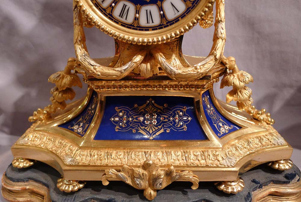 Antique French clock garniture in ormolu and enamelled ( jewelled) porcelain.