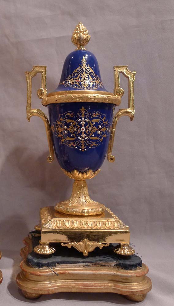 Antique French clock garniture in ormolu and enamelled ( jewelled) porcelain.