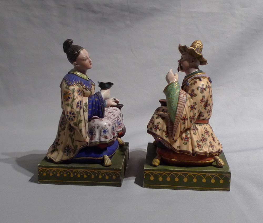 Antique French chinnoiserie pair or porcelain seated figures.