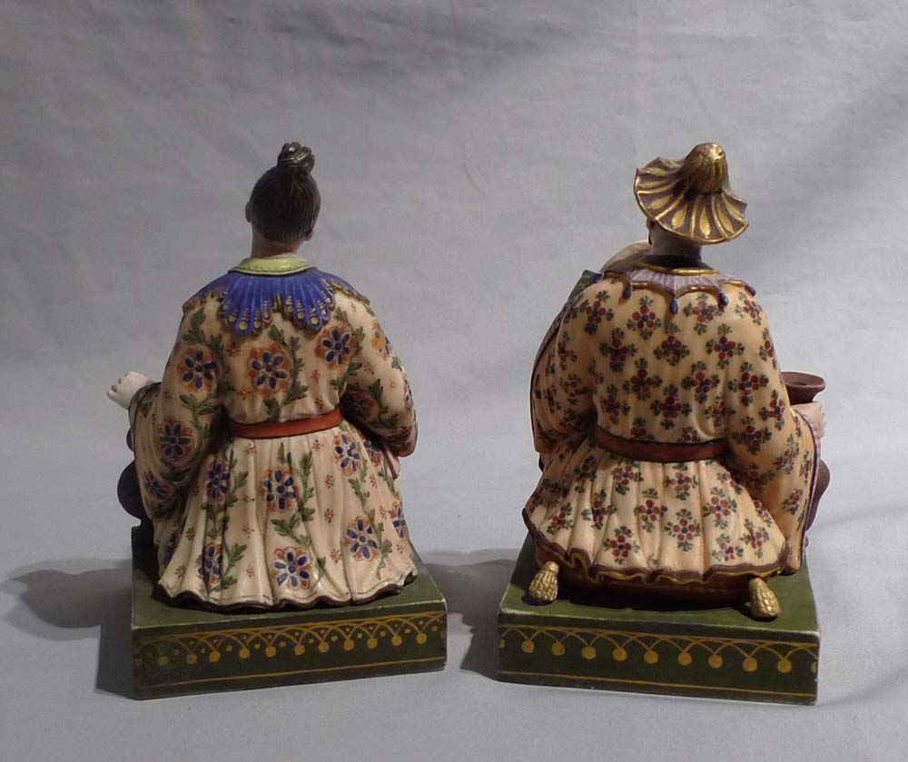 Antique French chinnoiserie pair or porcelain seated figures.