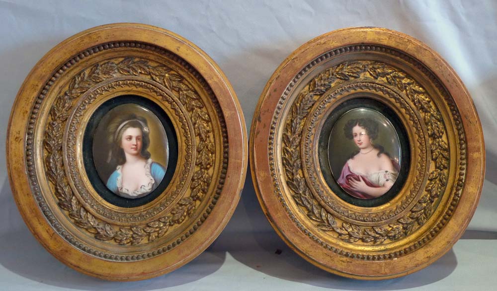 Pair porcelain hand painted oval plaques in oval giltwood frames.