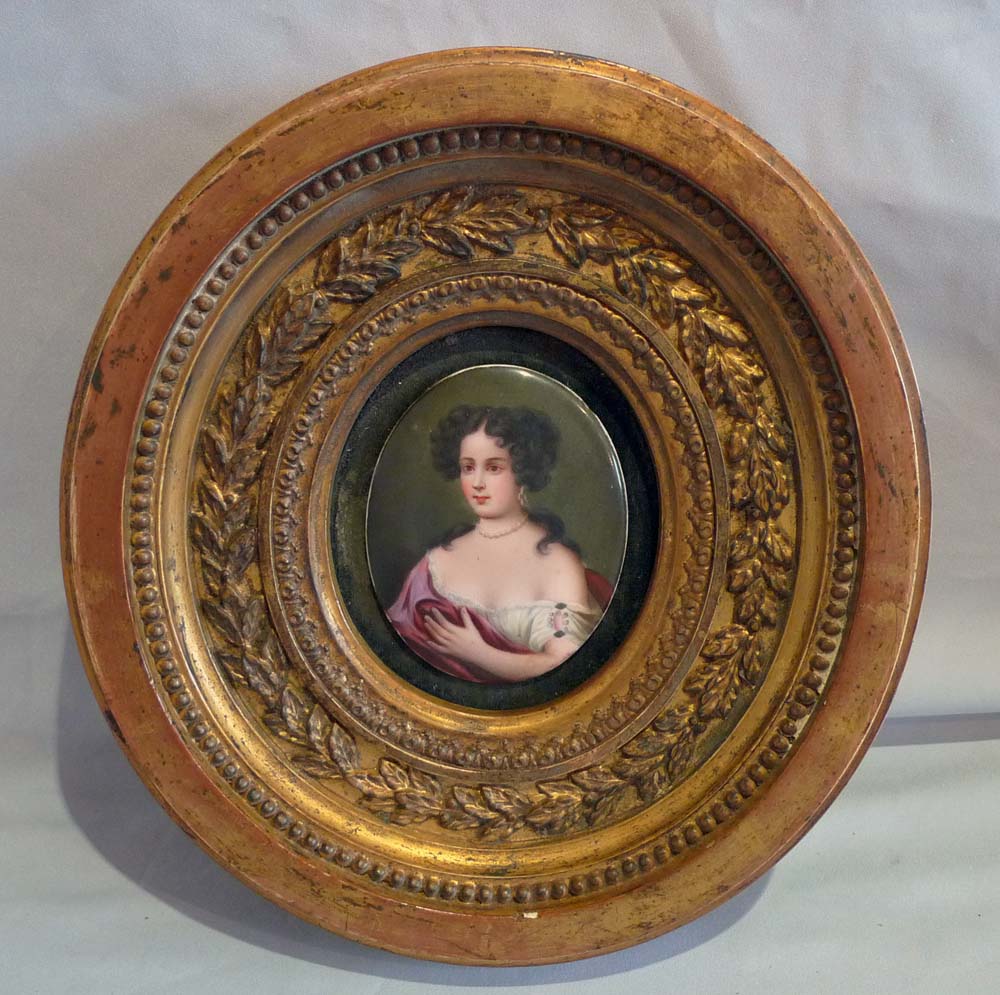 Pair porcelain hand painted oval plaques in oval giltwood frames.