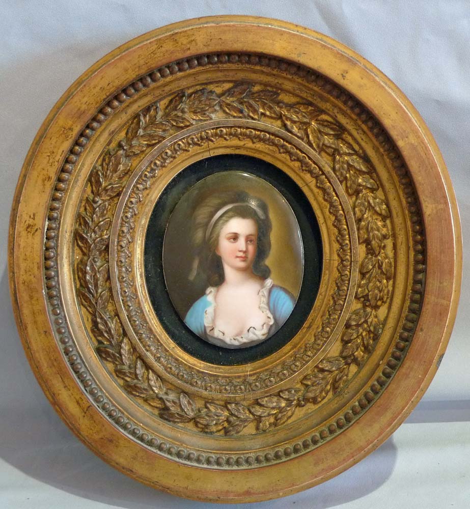 Pair porcelain hand painted oval plaques in oval giltwood frames.