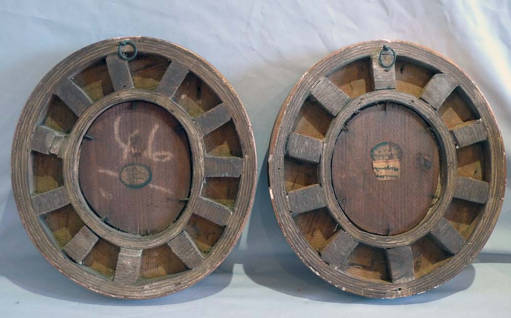 Pair porcelain hand painted oval plaques in oval giltwood frames.