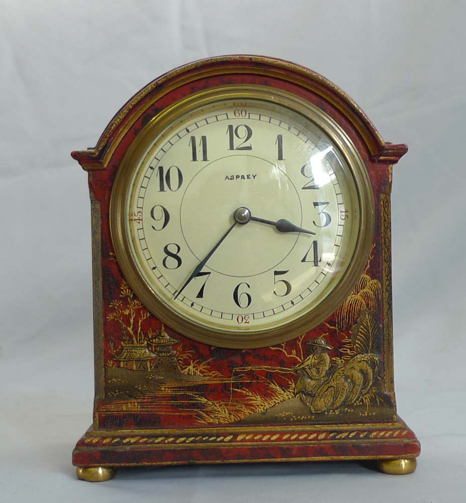 Antique Asprey chinnoiserie mantel clock in red lacquer.