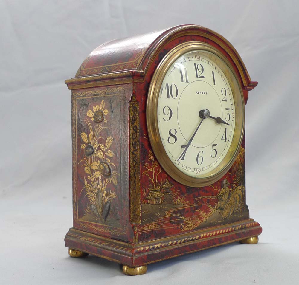 Antique Asprey chinnoiserie mantel clock in red lacquer.