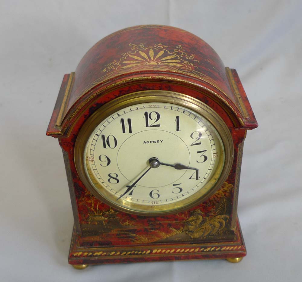 Antique Asprey chinnoiserie mantel clock in red lacquer.