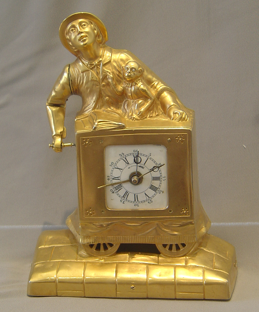 Swiss automaton organ grinder clock with musical box set off by the alarm..