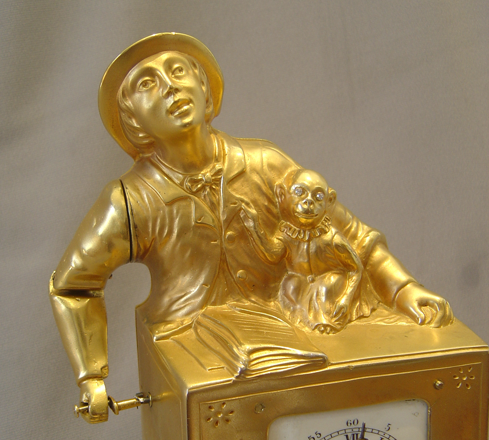 Swiss automaton organ grinder clock with musical box set off by the alarm..