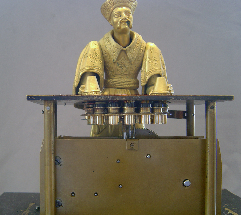 Magician automaton clock by Houdin.
