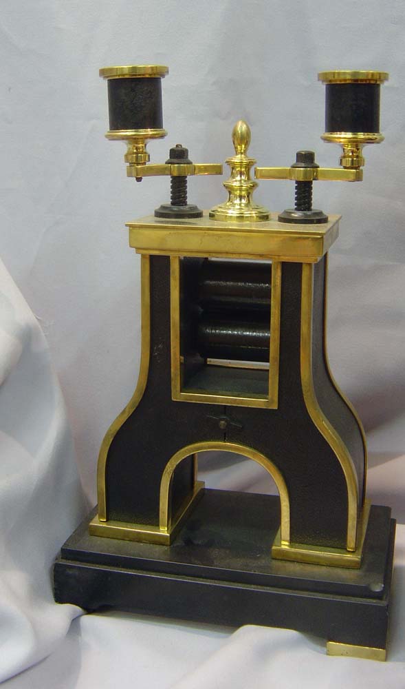antique automaton clock set of industrial steamhammer and rollers.