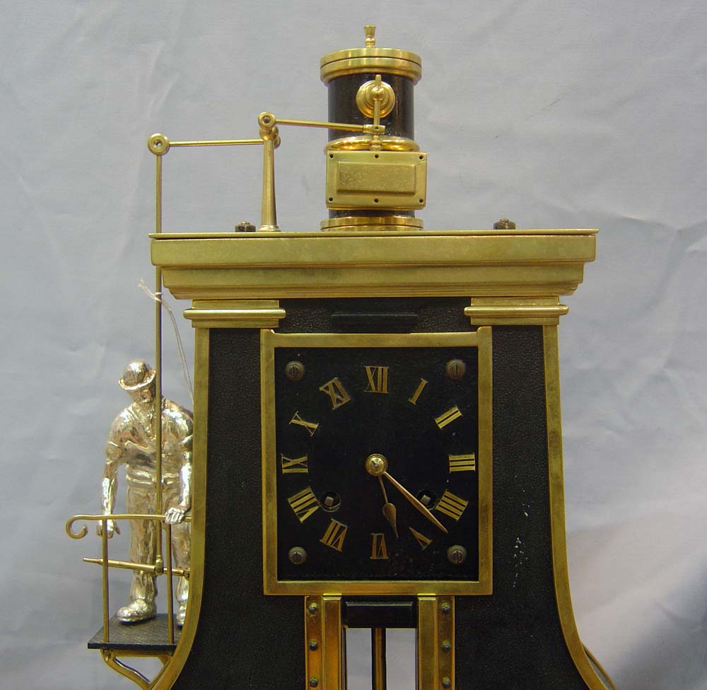 antique automaton clock set of industrial steamhammer and rollers.