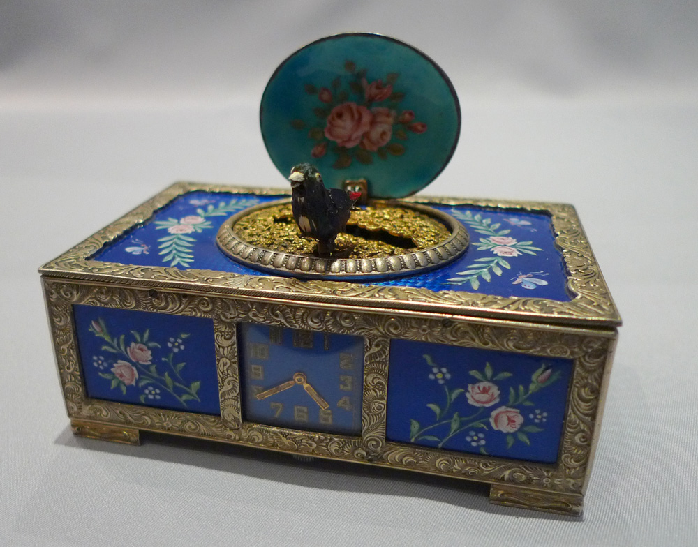 Rare singing bird box in silver and blue guilloche enamel with watch to front of case.