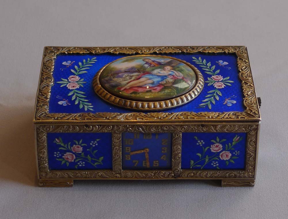 Rare singing bird box in silver and blue guilloche enamel with watch to front of case.