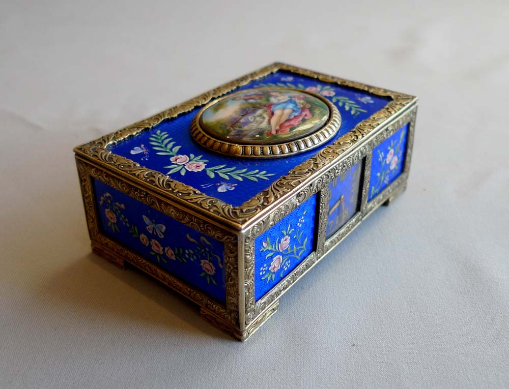 Rare singing bird box in silver and blue guilloche enamel with watch to front of case.