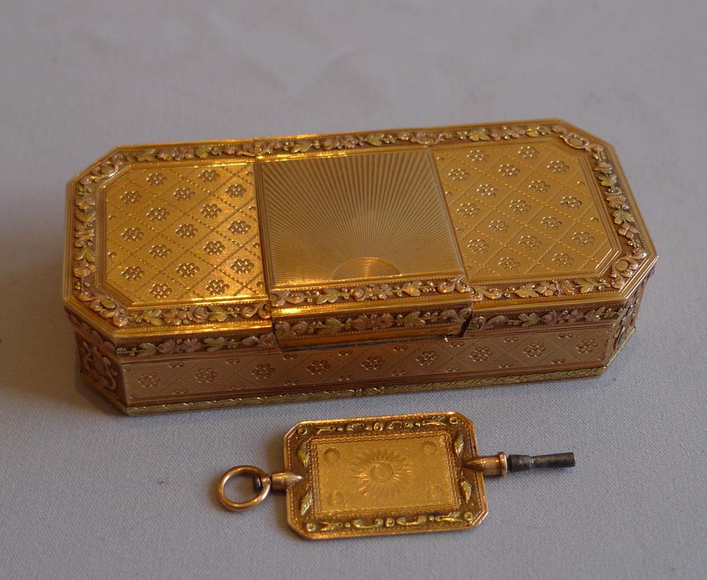 Antique three colour gold snuff box with fusee timepiece and three colour gold key.
