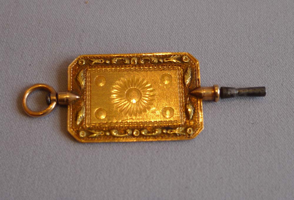 Antique three colour gold snuff box with fusee timepiece and three colour gold key.