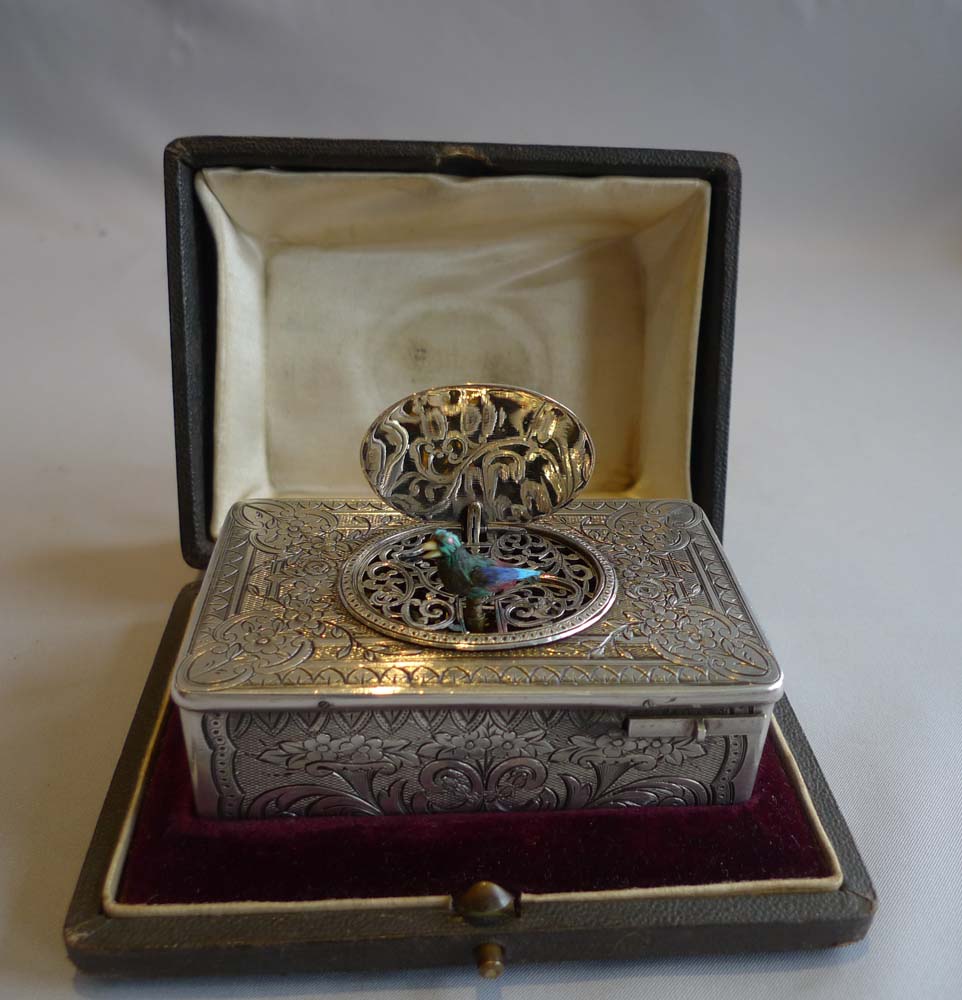 Antique singing bird box in silver with original box by unusual Swiss maker.