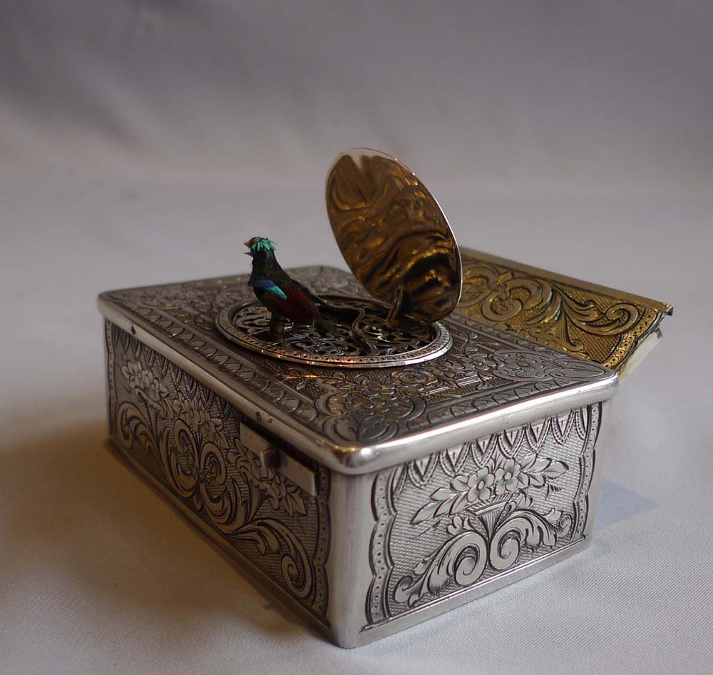 Antique singing bird box in silver with original box by unusual Swiss maker.