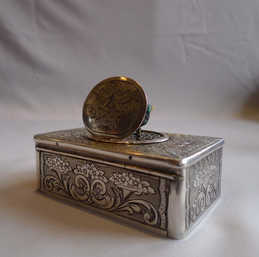 Antique singing bird box in silver with original box by unusual Swiss maker.