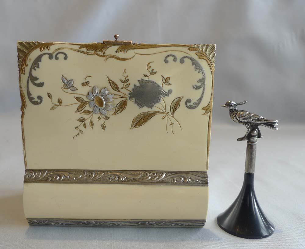 Singing bird box in silver and enamelling in book form by Griesbaum.