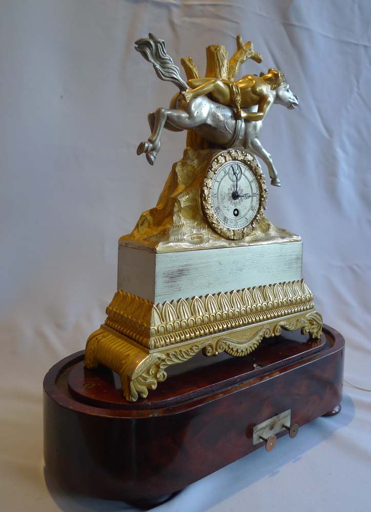 Charles X silvered bronze and ormolu miniature mantel clock on musical base.