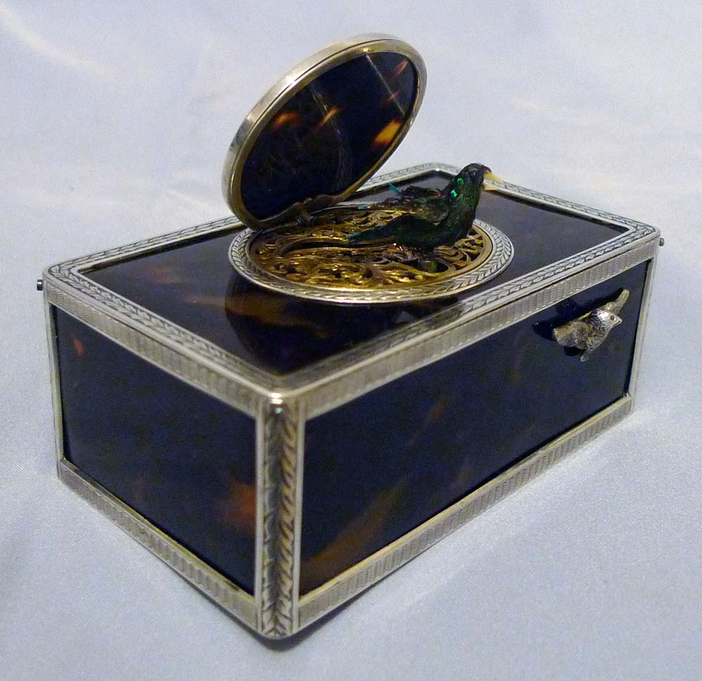Singing bird box silver with tortoiseshell panels and lid.