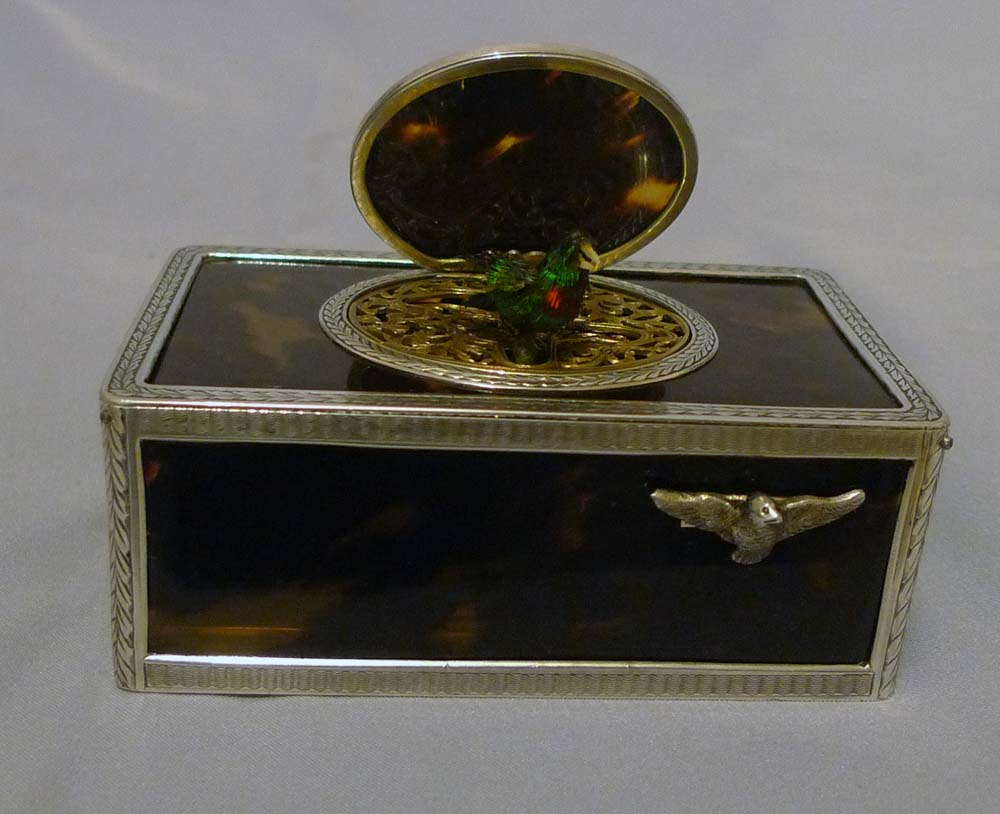 Singing bird box silver with tortoiseshell panels and lid.