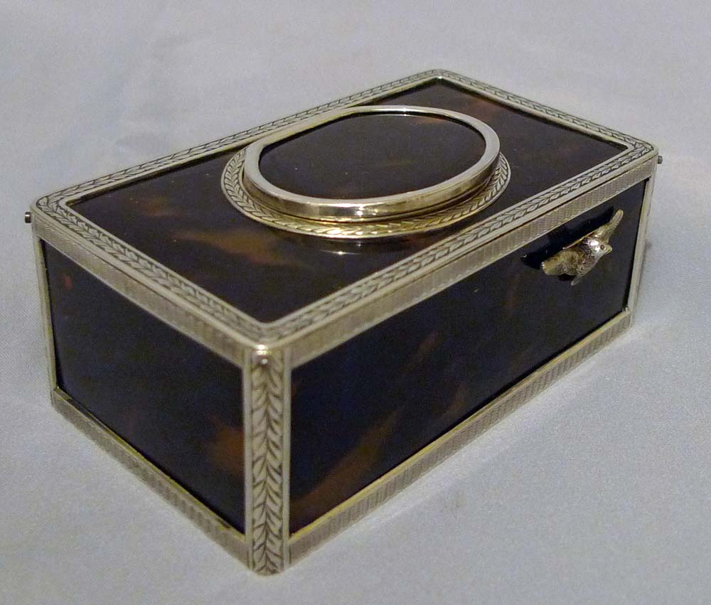 Singing bird box silver with tortoiseshell panels and lid.