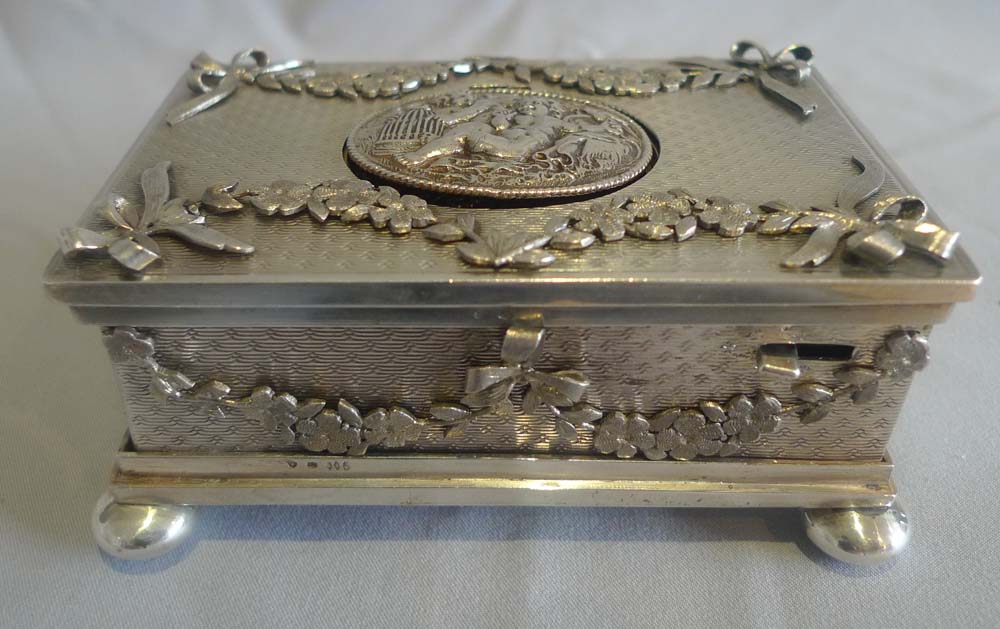 Singing bird box in solid silver with applied swags and bows..