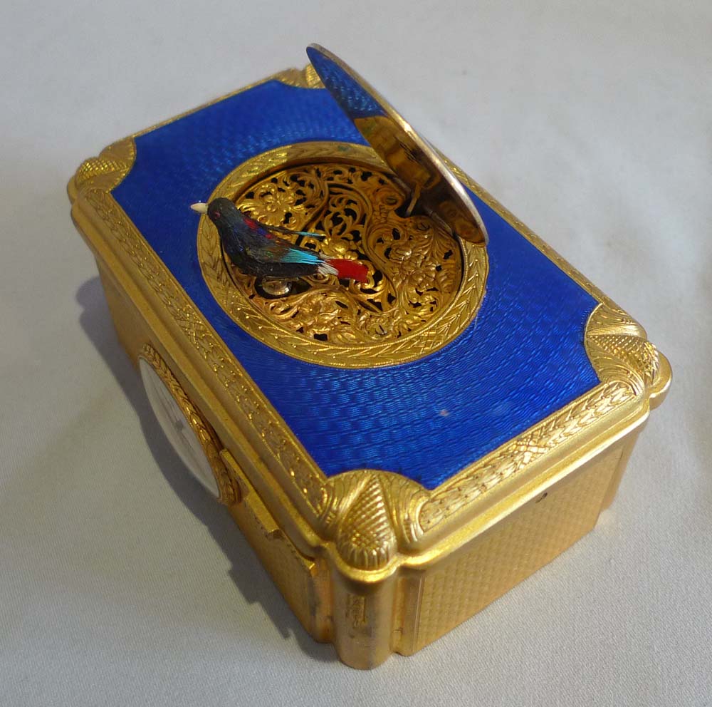 Singing bird box with watch inset in guilloche enamel and gilt bronze in original case.