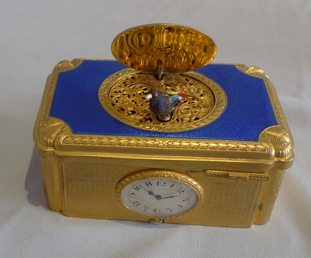 Singing bird box with watch inset in guilloche enamel and gilt bronze in original case.