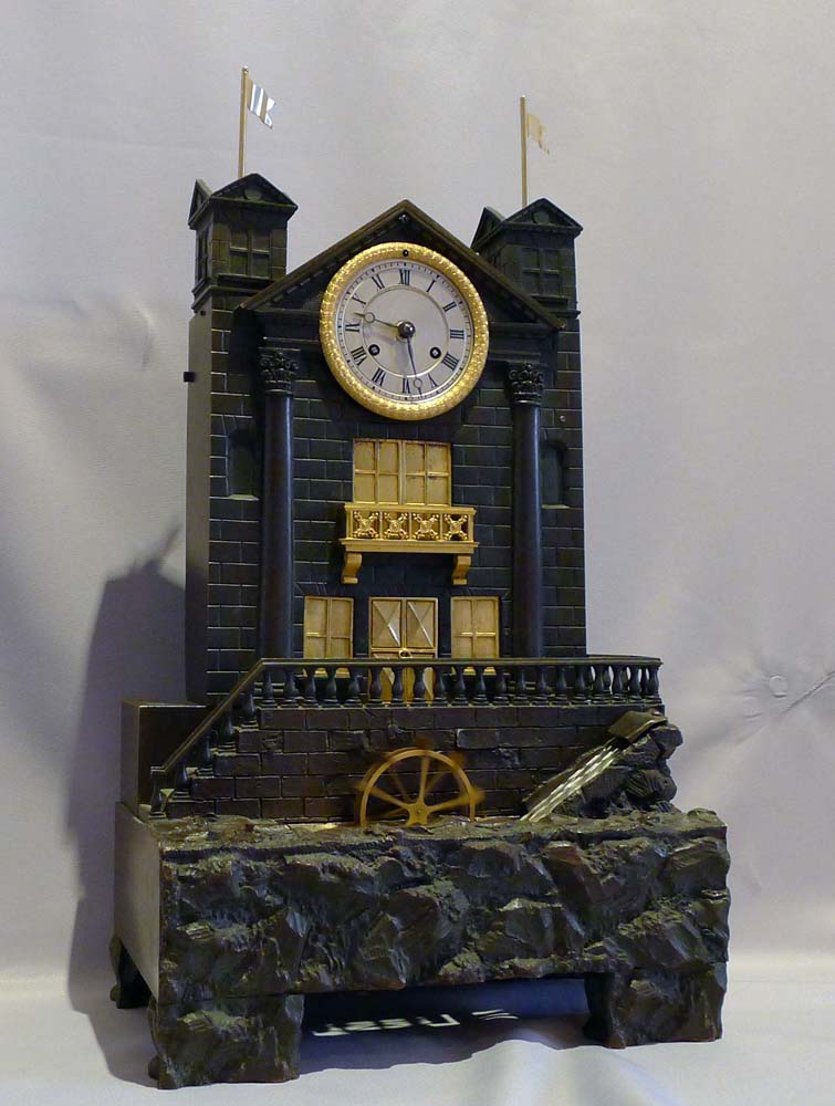 Antique French automaton striking mantel clock with moving water and waterwheel.