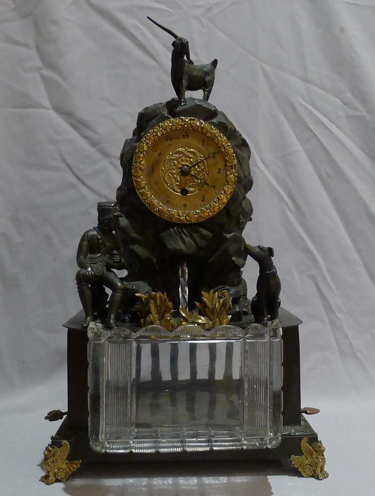 Antique automaton bronze mantel clock with moving water mechanism and hunting scene.