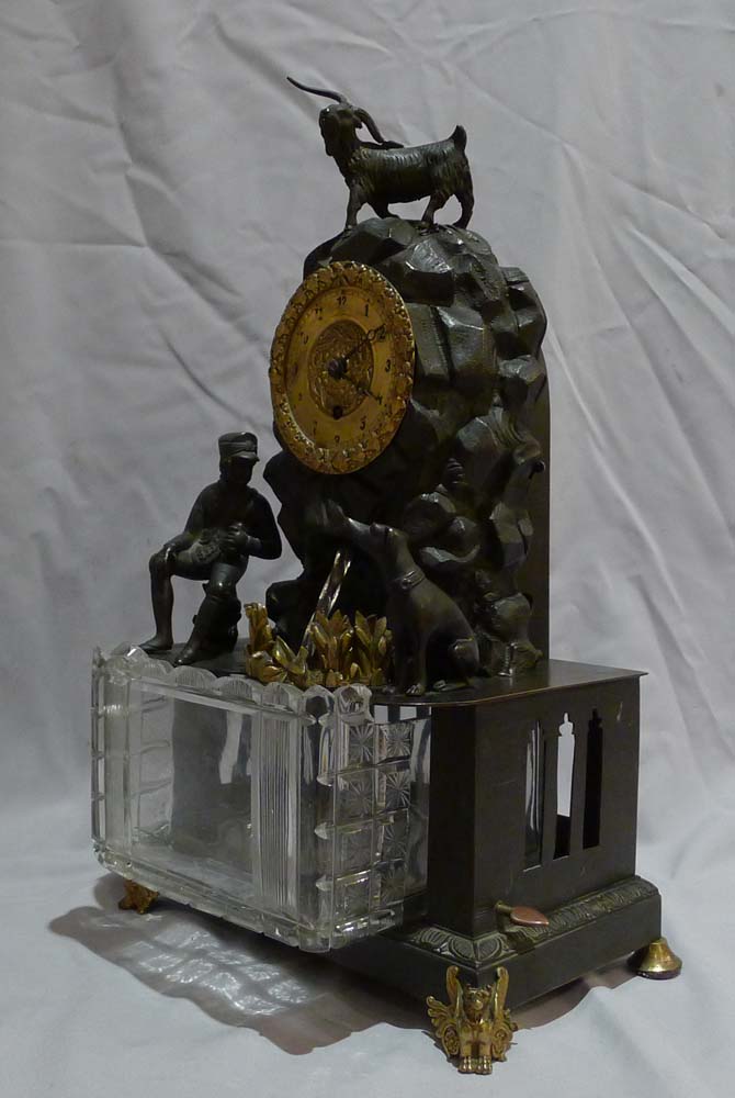 Antique automaton bronze mantel clock with moving water mechanism and hunting scene.