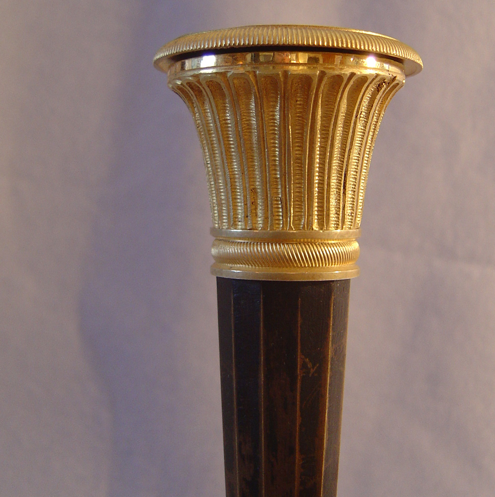 Antique pair of French Directoire patinated bronze & ormolu candlesticks.