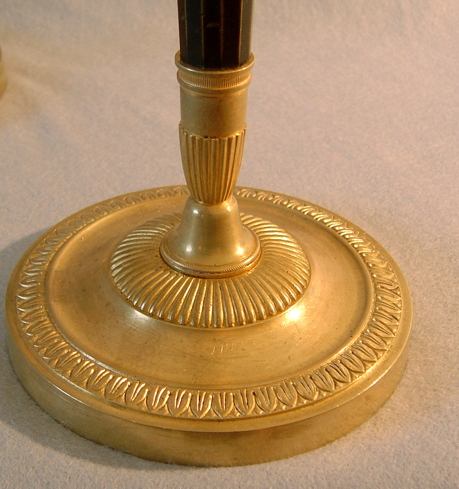 Antique pair of French Directoire patinated bronze & ormolu candlesticks.