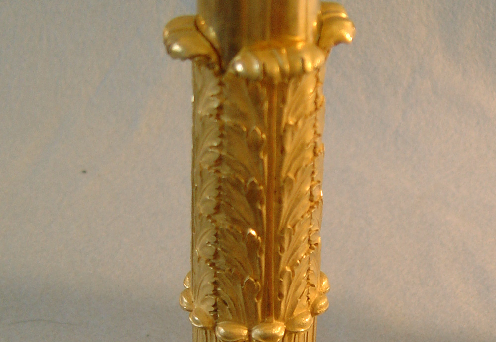 Antique French Empire pair of ormolu and patinated bronze candlesticks.