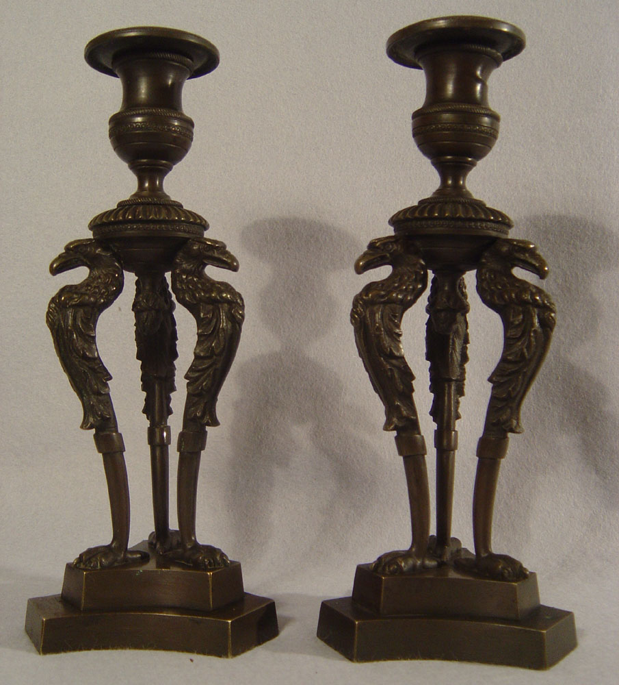 Antique pair of English George IV patinated bronze triform eagle candlesticks.