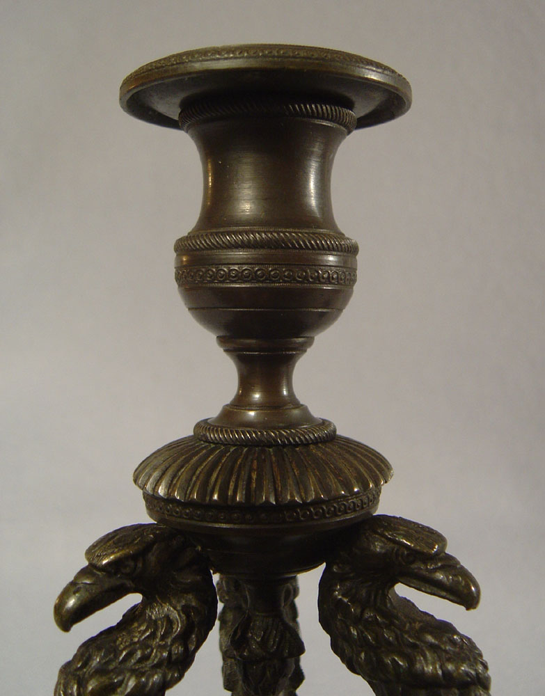 Antique pair of English George IV patinated bronze triform eagle candlesticks.