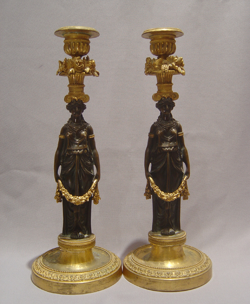 Antique candlesticks French Empire in ormolu and patinated bronze.