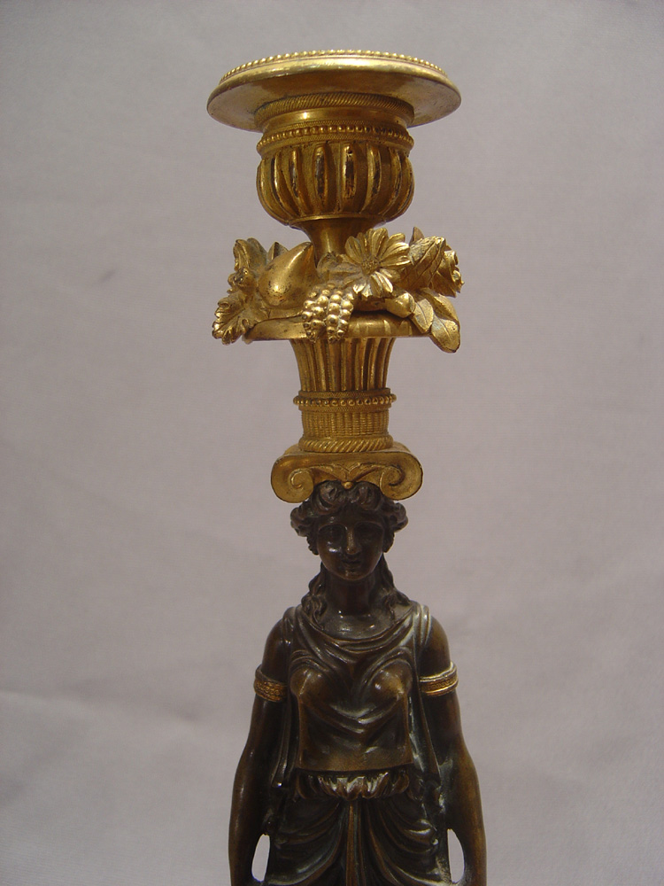 Antique candlesticks French Empire in ormolu and patinated bronze.