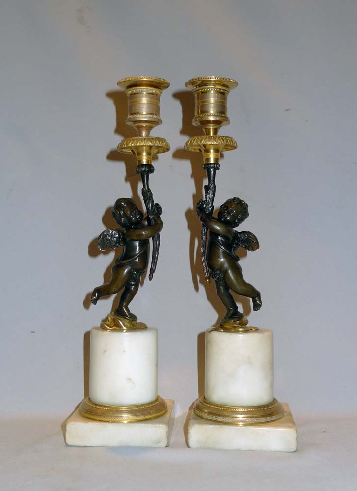 Pair English Regency figural candlesticks in carrera marble, ormolu and patinated bronze.