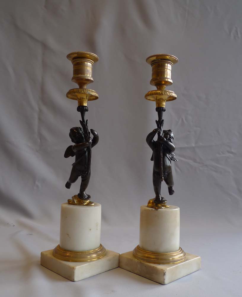 Pair English Regency figural candlesticks in carrera marble, ormolu and patinated bronze.