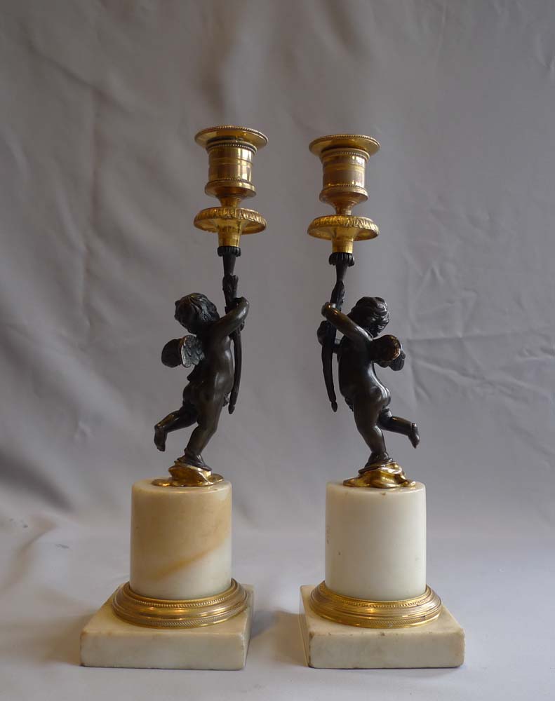 Pair English Regency figural candlesticks in carrera marble, ormolu and patinated bronze.