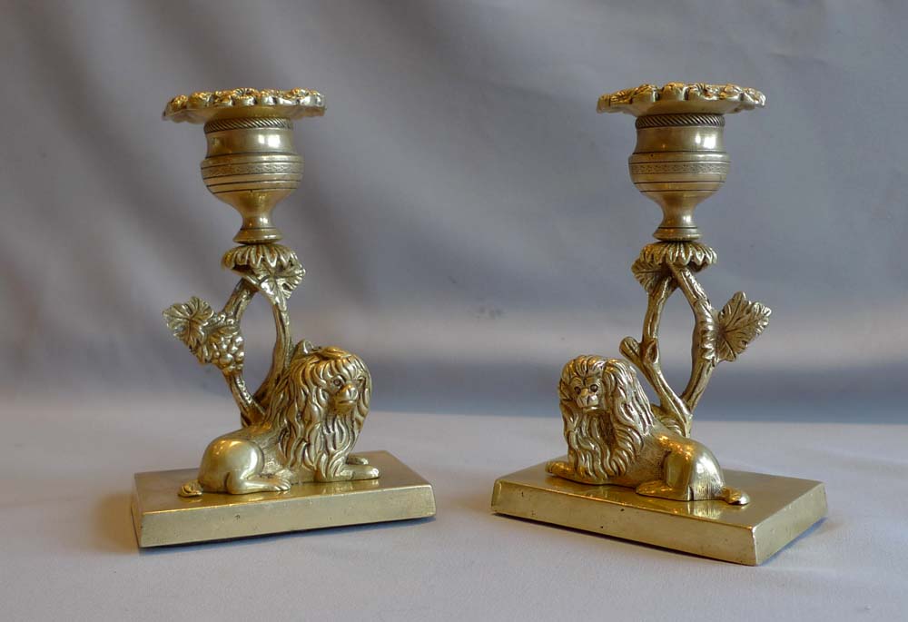 Pair English Regency naïve ormolu candlesticks with King Charles spaniels.
