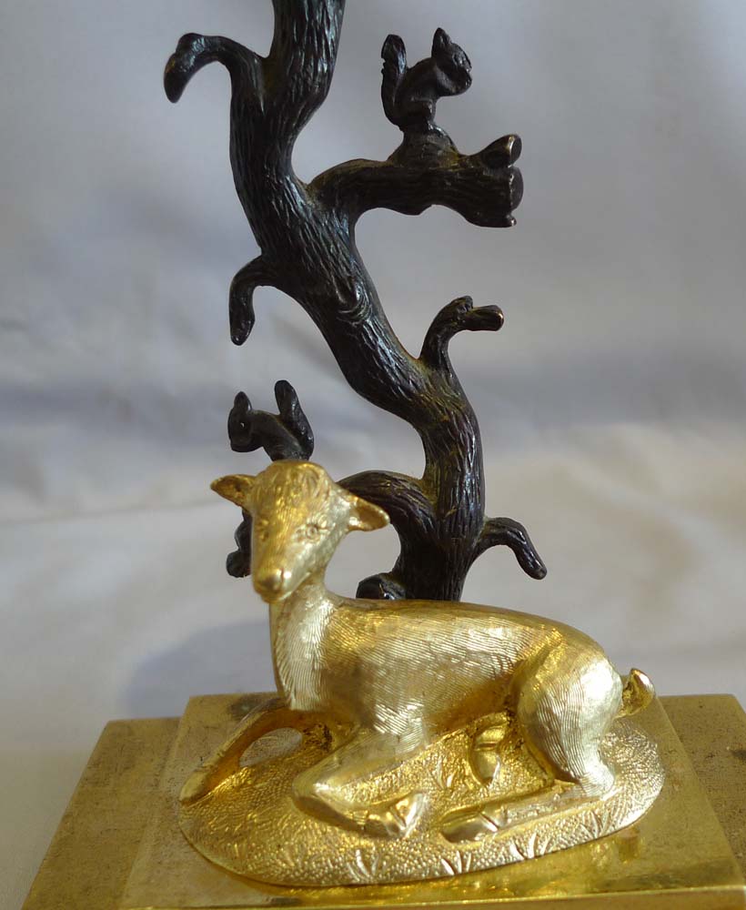 Antique English Regency candlestick of deer and squirrels in patinated bronze and ormolu.